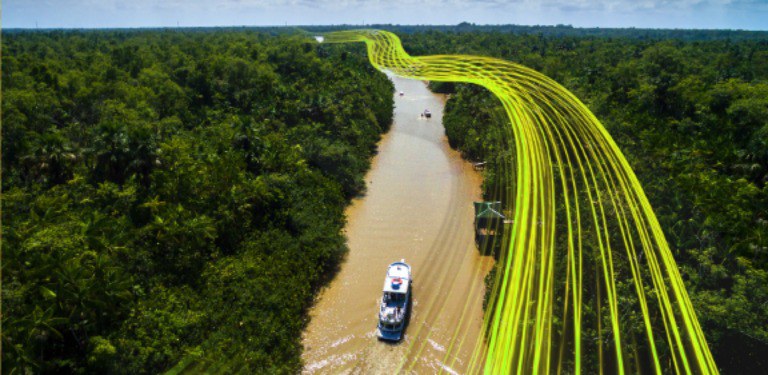 Barco navega em um rio no meio de uma floresta, linhas amarelas flutuantes paralelas ao rio e acima do barco  representam o acesso à conectividade
