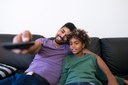 father-and-daughter-sitting-in-comfortable-sofa-and-watching-television.jpg