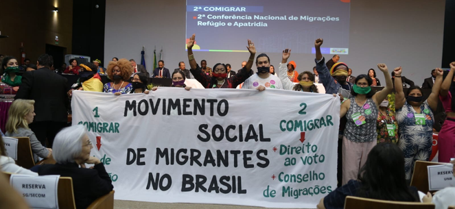 Pessoas reunidas na Conferência Nacional de Migrações, Refúgio e Apatridia