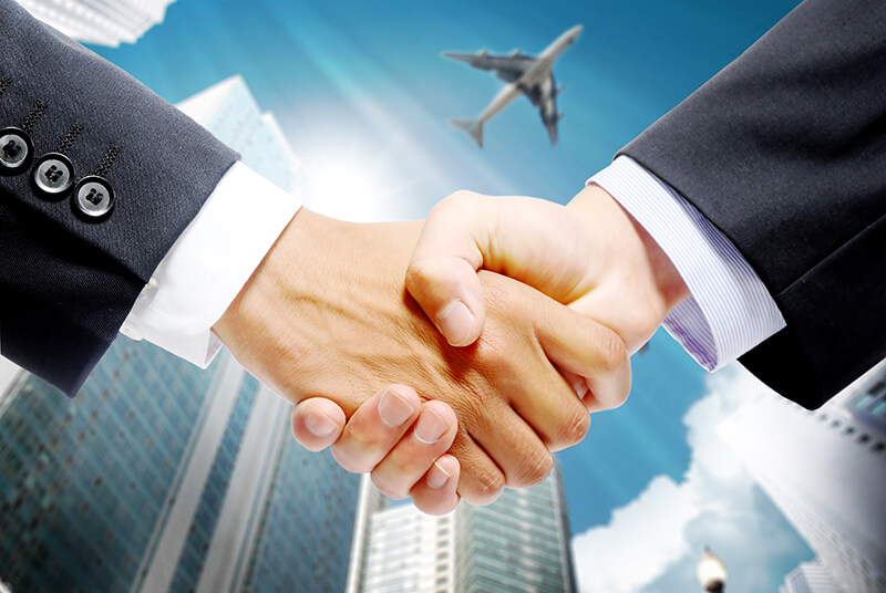 handshakeairplanebackgroundmanfeiyangiStockGettyImagesPlusGettyImages.jpg